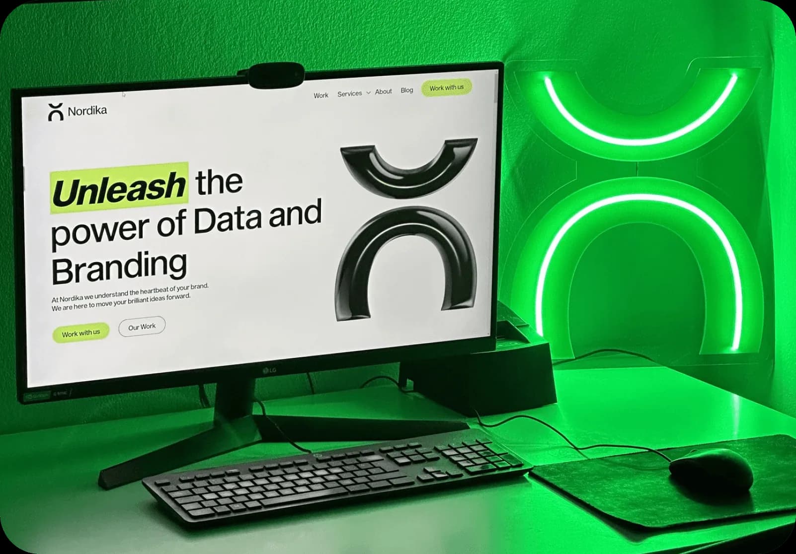 Nordika website on a desktop monitor lit in green