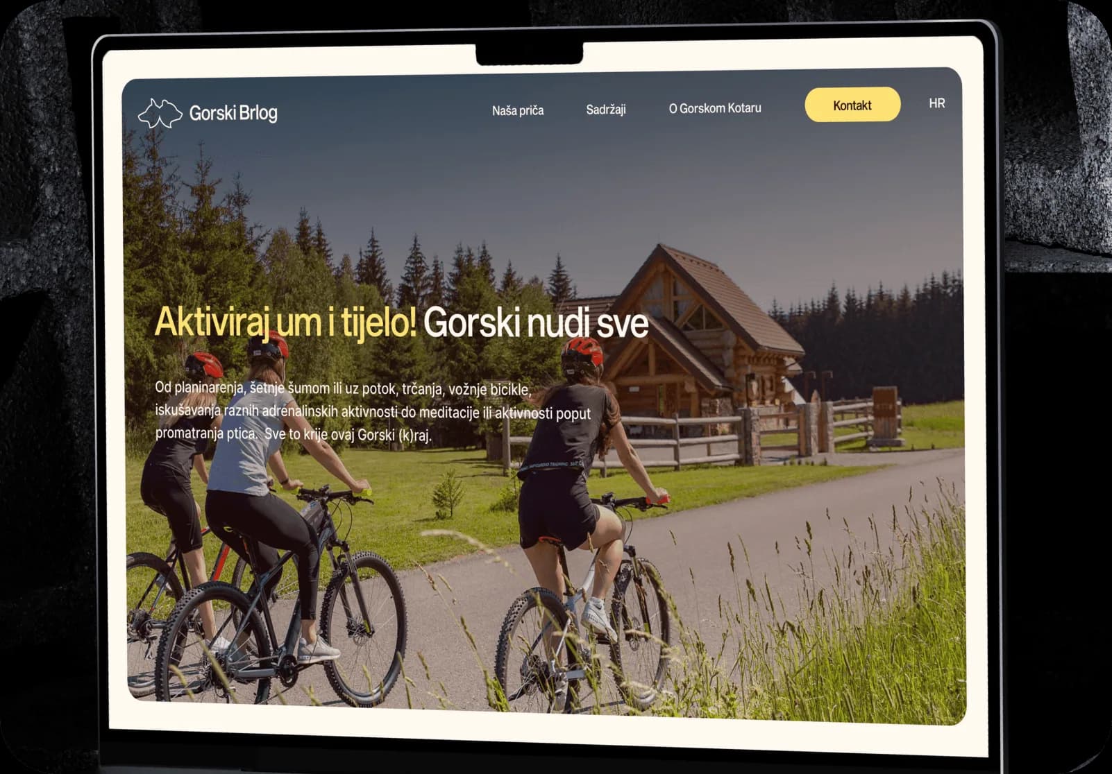 Gorski Brlog website on a tablet: cyclists on a forest trail