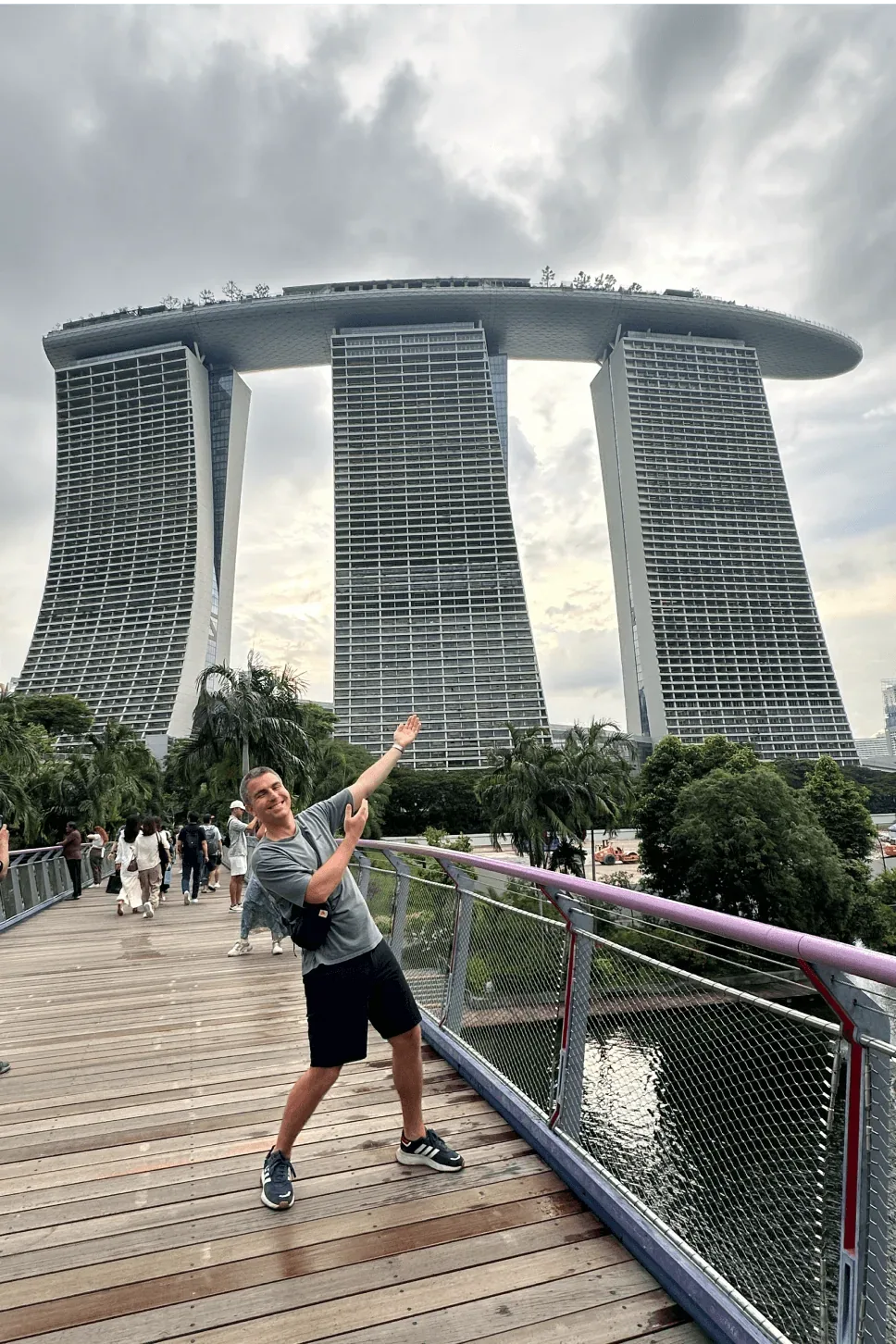Dejan posing on a skywalk in front of Marina Bay Sands